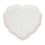 The Juliska Berry & Thread Whitewash Heart Serveware Collection features a white ceramic heart-shaped platter with a ruffled rim and delicate dotted and ridged detailing around the edge.