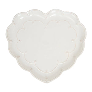 The Juliska Berry & Thread Whitewash Heart Serveware Collection features a white ceramic heart-shaped platter with a ruffled rim and delicate dotted and ridged detailing around the edge.