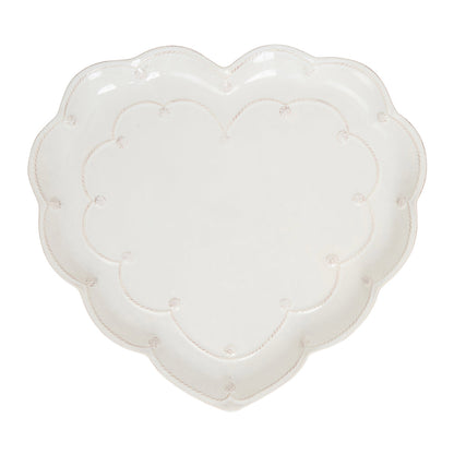 The Juliska Berry & Thread Whitewash Heart Serveware Collection features a white ceramic heart-shaped platter with a ruffled rim and delicate dotted and ridged detailing around the edge.