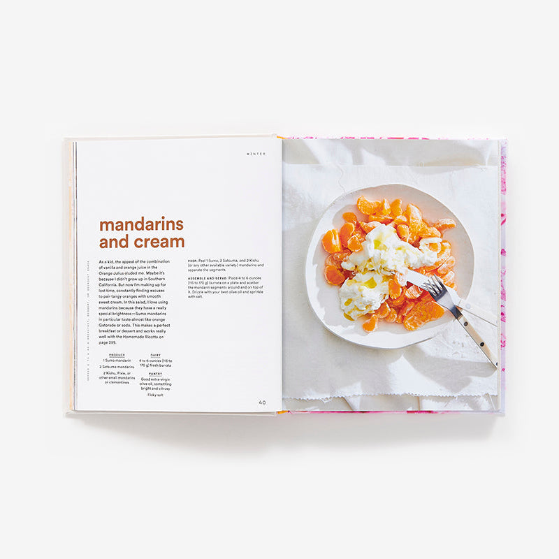 An open copy of Salad Freak: Recipes to Feed a Healthy Obsession by Abrams displays the "mandarins and cream" recipe on one page and a plate of mandarin segments topped with cream on the other.