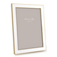 An Addison Ross Gold Trim Enamel Frame from the Gold Trim Enamel Frame Collection stands upright with a blank placeholder inside.