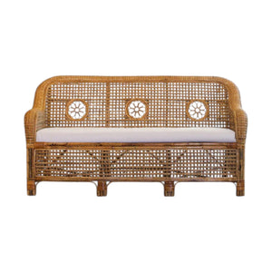 The Julianna Sofa by Varnish Collection is a handmade wicker loveseat with natural materials, a decorative woven backrest with three circular patterns, and a light cushion.