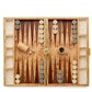 The Aerin Croc Leather Backgammon Set features wooden pieces, dice, a 32-point doubling cube, and a dice cup—all arranged on a patterned wooden surface and elegantly crafted with refined crocodile-embossed Italian leather.