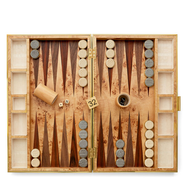 The Aerin Croc Leather Backgammon Set features wooden pieces, dice, a 32-point doubling cube, and a dice cup—all arranged on a patterned wooden surface and elegantly crafted with refined crocodile-embossed Italian leather.