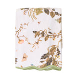 The Vivian Magnolia Floral Scallop Bath Towel by Weezie Towels features a botanical and butterfly print with green trim, crafted from quick-dry terry for comfort and convenience.