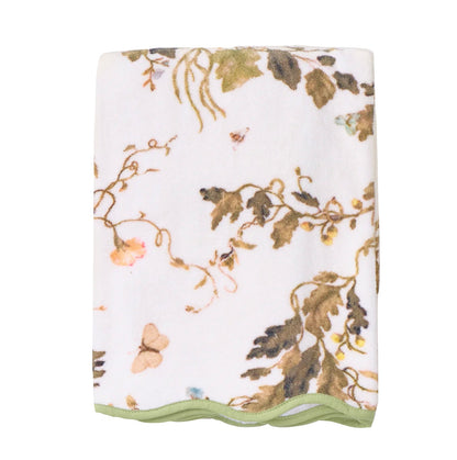The Vivian Magnolia Floral Scallop Bath Towel by Weezie Towels features a botanical and butterfly print with green trim, crafted from quick-dry terry for comfort and convenience.