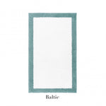 A rectangular white Egoist Border Bath Rug by Graciozza, crafted from soft Egyptian cotton with a customizable teal border, labeled "Baltic" below the image.