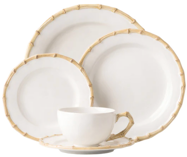 A set of ceramic dinnerware from the Juliska Classic Bamboo Collection with casual elegance, including plates in two sizes and a cup, featuring international flair with bamboo design edges.