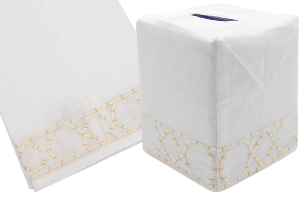 A cream Bamboozle Collection tissue box cover with a golden geometric embroidery design by Haute Home.