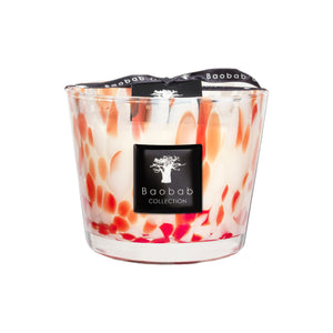 The Baobab Collection Pearls Coral Candle by Baobab features hand-blown glass with an orange and white marbled design, a black logo label, and is topped with a black ribbon.
