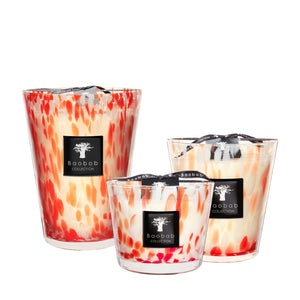Three Baobab Pearls Coral Candles by Baobab, each in hand-blown glass with orange and red speckles, finished with a black brand label and ribbon.