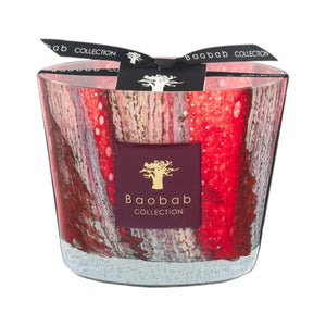 The Baobab Collection Woods Risoud Candle by Baobab features a red and white marbled glass design with a black ribbon and gold logo, adding artisan elegance to any space.