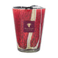 The Baobab Collection Woods Risoud Candle is a large red and white artisan glass candle in a holder with a Baobab label and a black ribbon on top.