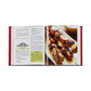 An open copy of The Barbecue Bible by Graphic Image shows a lamb and eggplant kebab recipe on the left and a close-up of skewered kebabs on the right—ideal inspiration for discovering new barbecue dishes.