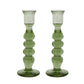 The Provence Candlestick Set by Juliska features a pair of green, mouth-blown glass candlesticks with a textured, bubble-like design and round bases, displayed on a white background.