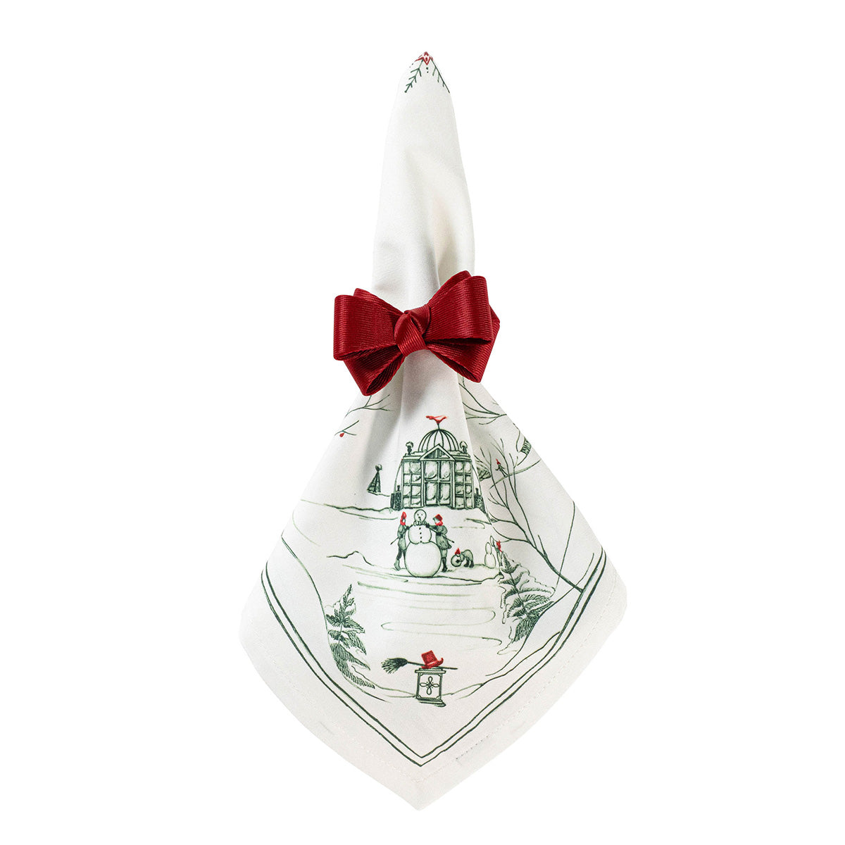 Juliska Evergreen Country Estate Winter Frolic Napkin secured with a red ribbon bow, featuring a green winter scene with snowmen and a gazebo.