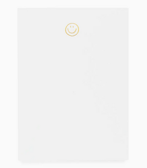 The Sugar Paper Mini Notepad, Smiley, features a petite white design with a cheerful yellow smiley at the top—perfect for brightening your notes.