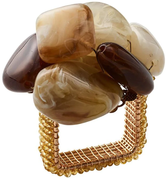 The Kim Seybert Sea Stone Napkin Ring features a square design, beaded gold-tone band, and polished brown and beige beach stones clustered on top—an elegant accent for your table setting.