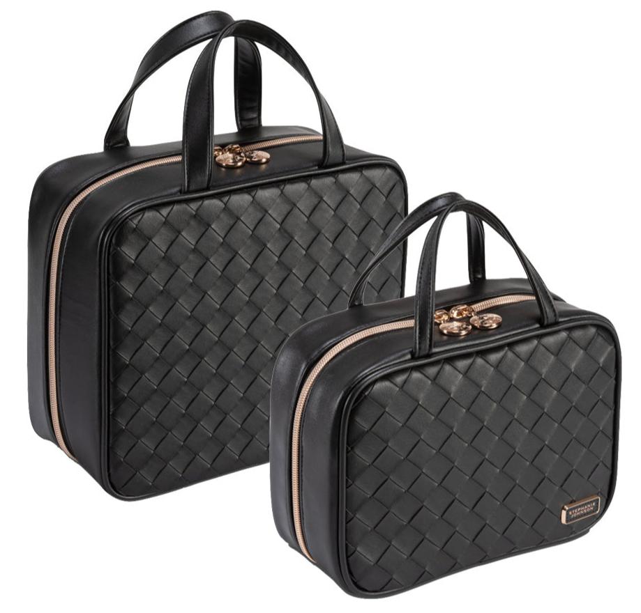 The Stephanie Johnson Belize Raven Travel Collection features two black woven bags with gold zippers and handles, shown in large and medium sizes. Each has removable compartments—ideal as a cosmetic case for travel. Set against a white background.