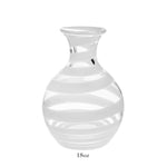 The Bella Bianca Carafe Collection by William Yeoward Crystal features a clear glass carafe with white stripes, round body, narrow neck, and flared rim. Shown on white background with "18oz" below. Proposition 65 warning applies; ideal for serving wine.