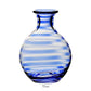 The Bella Blue Carafe Collection by William Yeoward Crystal features a round glass carafe with blue and clear horizontal stripes, a narrow neck, and flat base. Holds 35 oz., ideal for wine. Proposition 65 warning: may contain harmful materials.