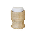 The Belle Stool by Varnish Collection is a round wicker stool with a flared base and a white cushioned seat, providing cozy, tuffet-inspired seating on a plain white background.