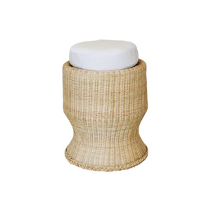 The Belle Stool by Varnish Collection is a round wicker stool with a flared base and a white cushioned seat, providing cozy, tuffet-inspired seating on a plain white background.