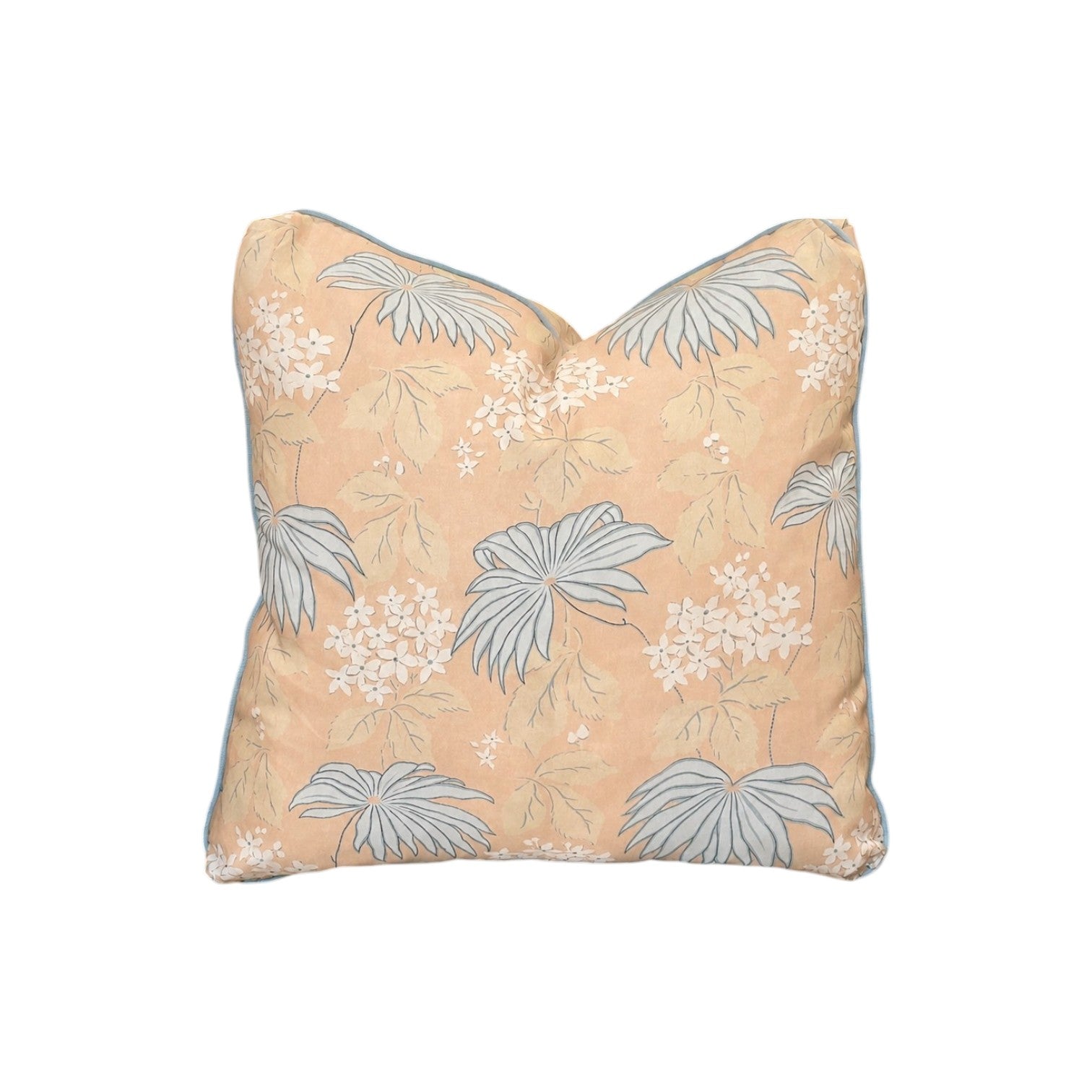 The Bellini Pillow by Hive Custom Pillows features a peach background with light blue and white floral and leaf accents, crafted from premium materials for a luxurious touch, shown on a plain white backdrop.
