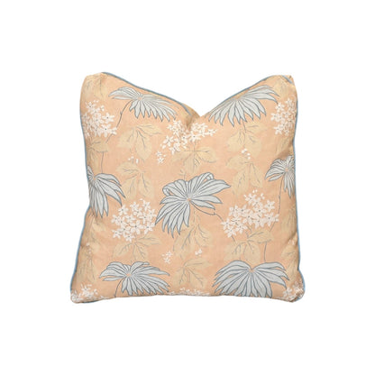 The Bellini Pillow by Hive Custom Pillows features a peach background with light blue and white floral and leaf accents, crafted from premium materials for a luxurious touch, shown on a plain white backdrop.