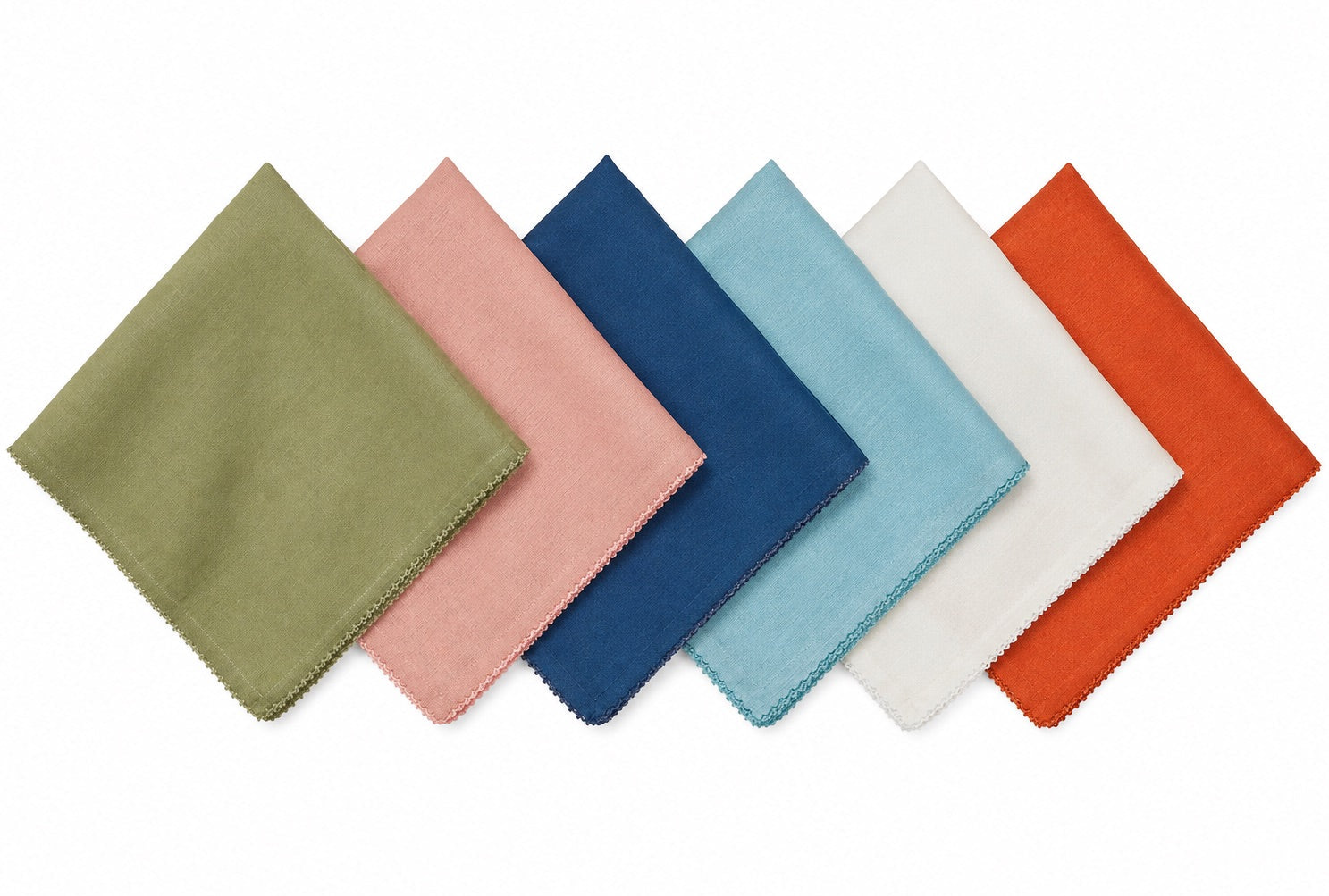 Six square linen napkins from the Juliska Berry Scallop Napkin & Tablecloth Collection are arranged in a row, each showcasing a different color—green, pink, blue, light blue, white, and orange—against a crisp white background. These finely woven pieces pair beautifully with matching or contrasting linens from the collection to create an inviting table setting.