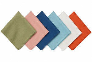 Six square linen napkins from the Juliska Berry Scallop Napkin & Tablecloth Collection are arranged in a row, each showcasing a different color—green, pink, blue, light blue, white, and orange—against a crisp white background. These finely woven pieces pair beautifully with matching or contrasting linens from the collection to create an inviting table setting.