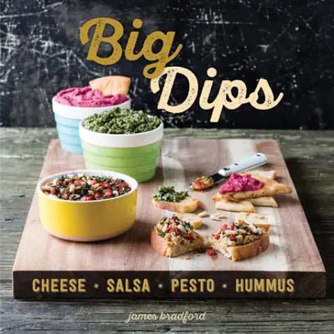 On a wooden board with bread slices, four bowls of tasty dips labeled cheese, salsa, pesto, and hummus are arranged. The title "Big Dips" by Gibbs Smith is prominently displayed above, making it an ideal choice for party appetizers.