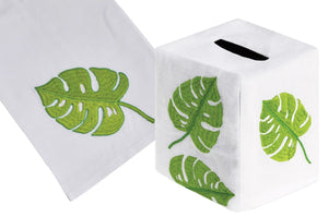 The Big Green Leaf Bath Collection from Haute Home includes a hand towel and tissue box cover, both showcasing exquisite Italian linen with hand-embroidered green leaf designs.