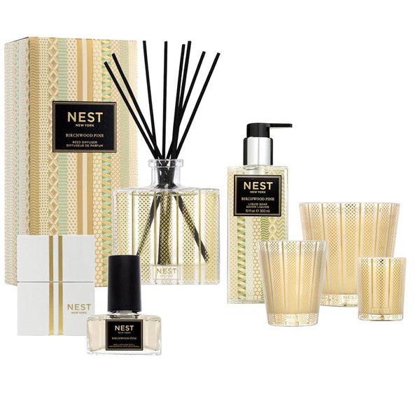 Explore the Nest Birchwood Pine Collection, which encapsulates the spirit of a winter forest with its range of products, including a diffuser, candle, hand soap, and perfume. Each item is exquisitely packaged for a magical experience.