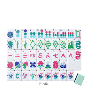 The Oh My Mahjong Mahjong Tile Collection features a full set of hand-painted tiles arranged in rows on a white background, with one tile from the collection placed slightly apart in the lower right corner.