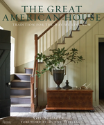 The cover of The Great American House by Rizzoli features a hallway with a wooden staircase, a chest topped with a vase of greenery, and the title by Gil Schafer III, beautifully capturing the timeless elegance of classical architecture.