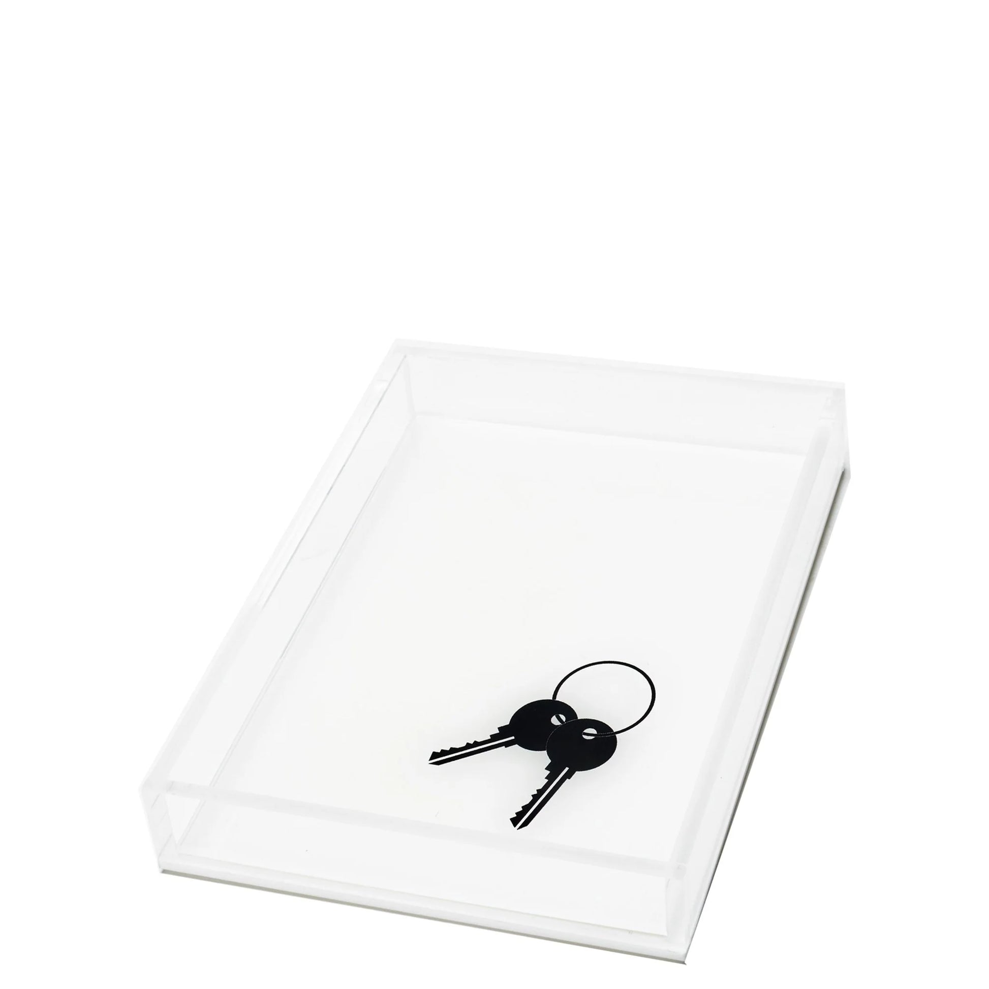 The Tara Wilson Designs “Black Keys on White Acrylic Tray” features a rectangular white acrylic tray displaying a set of two black keys on a keyring, positioned near one corner against a plain white background.
