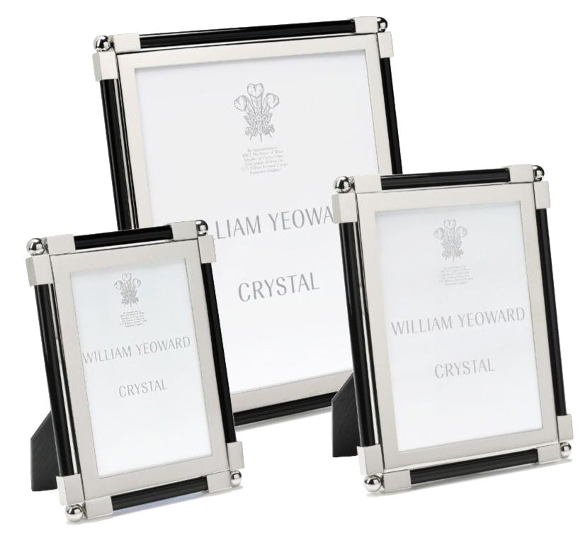 Three upright photo frames from the Black Classic Frame Collection by William Yeoward Crystal, finished in silver and black with a bright shine, each display placeholder paper labeled with the brand name.