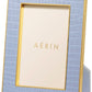 The Classic Croc Leather Frame Collection by Aerin is a rectangular blue photo frame with a gold border, crafted from Italian croc-embossed leather, featuring a placeholder card that says "AERIN.