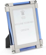 The Light Blue Classic Frame Collection by William Yeoward Crystal features a rectangular, nickel-plated photo frame with silver metal edges and blue glass accents; this classic item may carry a Proposition 65 warning.