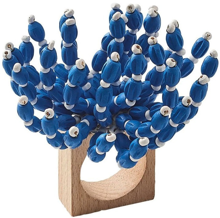 The Kim Seybert Reed Napkin Ring showcases blue and white wooden beads arranged to mimic a coral cluster, making it an ideal accent for coastal-inspired decor.