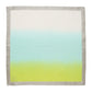 The Kim Seybert Dip Dye Napkin Set features square fabric napkins with a dip-dye gradient design transitioning from green to blue to white, accented by a light gray edge.