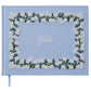 A light blue Riffle Paper Co. guestbook, featuring embroidered white flowers, green leaves, and "Guests" in white script, pairs beautifully with the Blue Hydrangea Desk Accessory Collection.