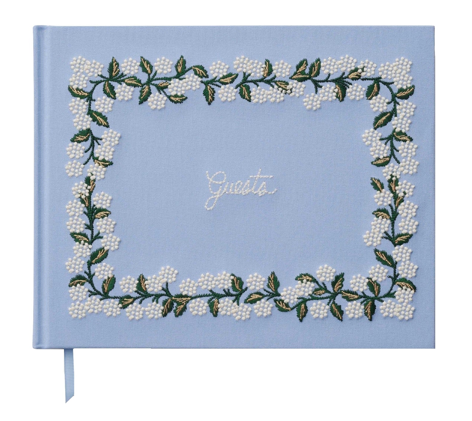 A light blue Riffle Paper Co. guestbook, featuring embroidered white flowers, green leaves, and "Guests" in white script, pairs beautifully with the Blue Hydrangea Desk Accessory Collection.
