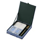 The Blue Hydrangea Desk Accessory Collection by Rifle Paper Co. features a stationery set with floral notecards, envelopes, a gold pen, and two wax seals in a green and blue case—perfect for organizing your desk in style.