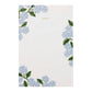 Rectangular notepad from Riffle Paper Co.’s Blue Hydrangea Desk Accessory Collection, featuring "MEMO" in gold at the top and blue hydrangea floral designs with green leaves in the corners—an elegant desk accent.