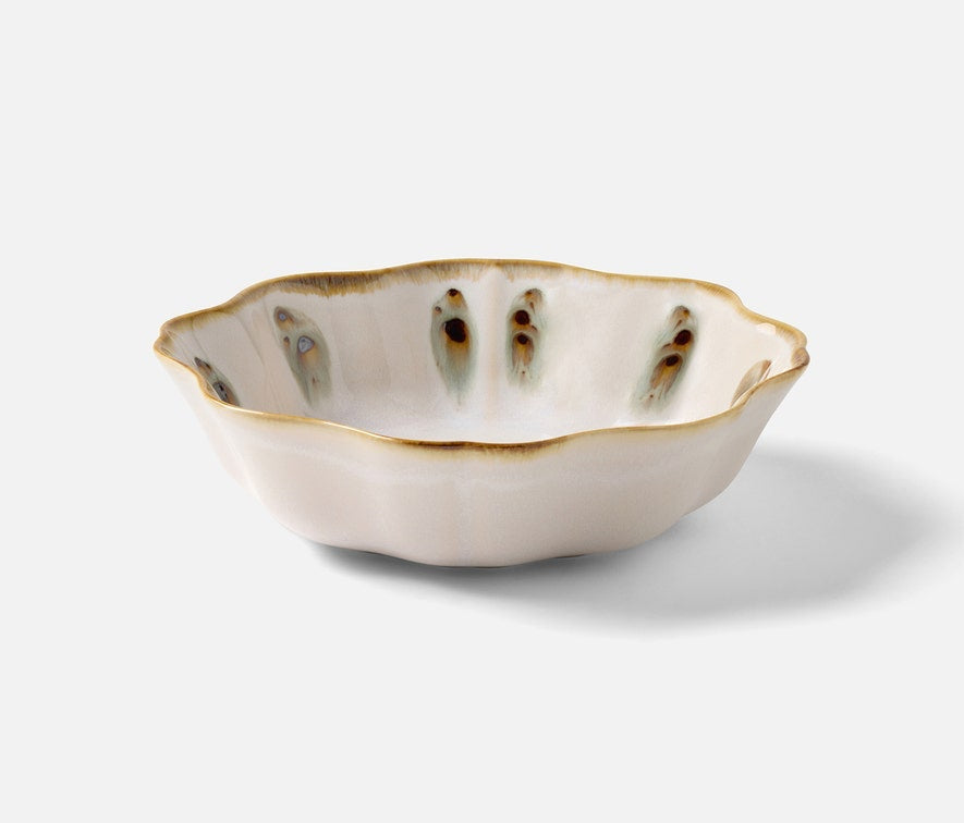 The Amoria Dinnerware Collection by Blue Pheasant features a scalloped ceramic bowl with a white reactive glaze, brown-edged rim, and vertical brown and green accents, radiating vintage-inspired elegance on a white background.