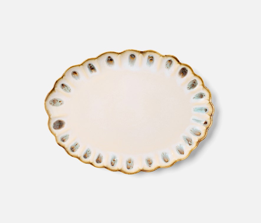 The Amoria Dinnerware Collection by Blue Pheasant features an oval ceramic plate with scalloped edges, a beige center, and brown-and-blue accents from reactive glaze, adding vintage-inspired charm to your table.