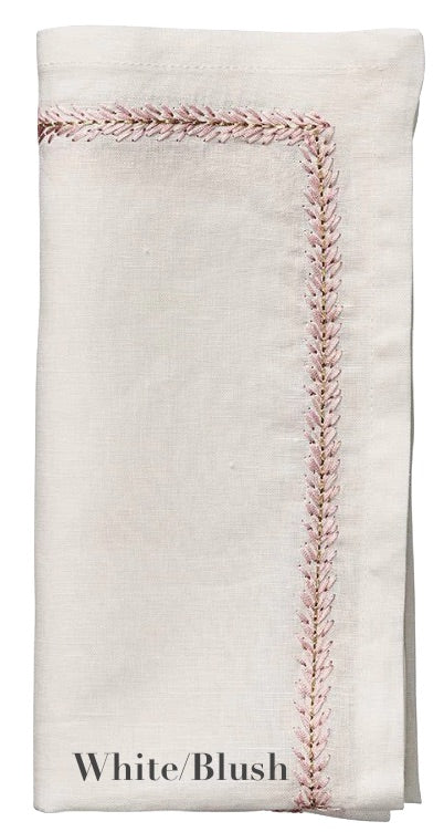 The Kim Seybert Jardin Napkin Set in "White/Blush" features folded white linen napkins with pink decorative edge stitching and delicate embroidery for an elegant touch.