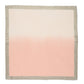 The Kim Seybert Dip Dye Napkin Set features square fabric napkins with a beige border and an ombre design, hand-dipped to fade from light at the top to a deeper pink at the bottom.